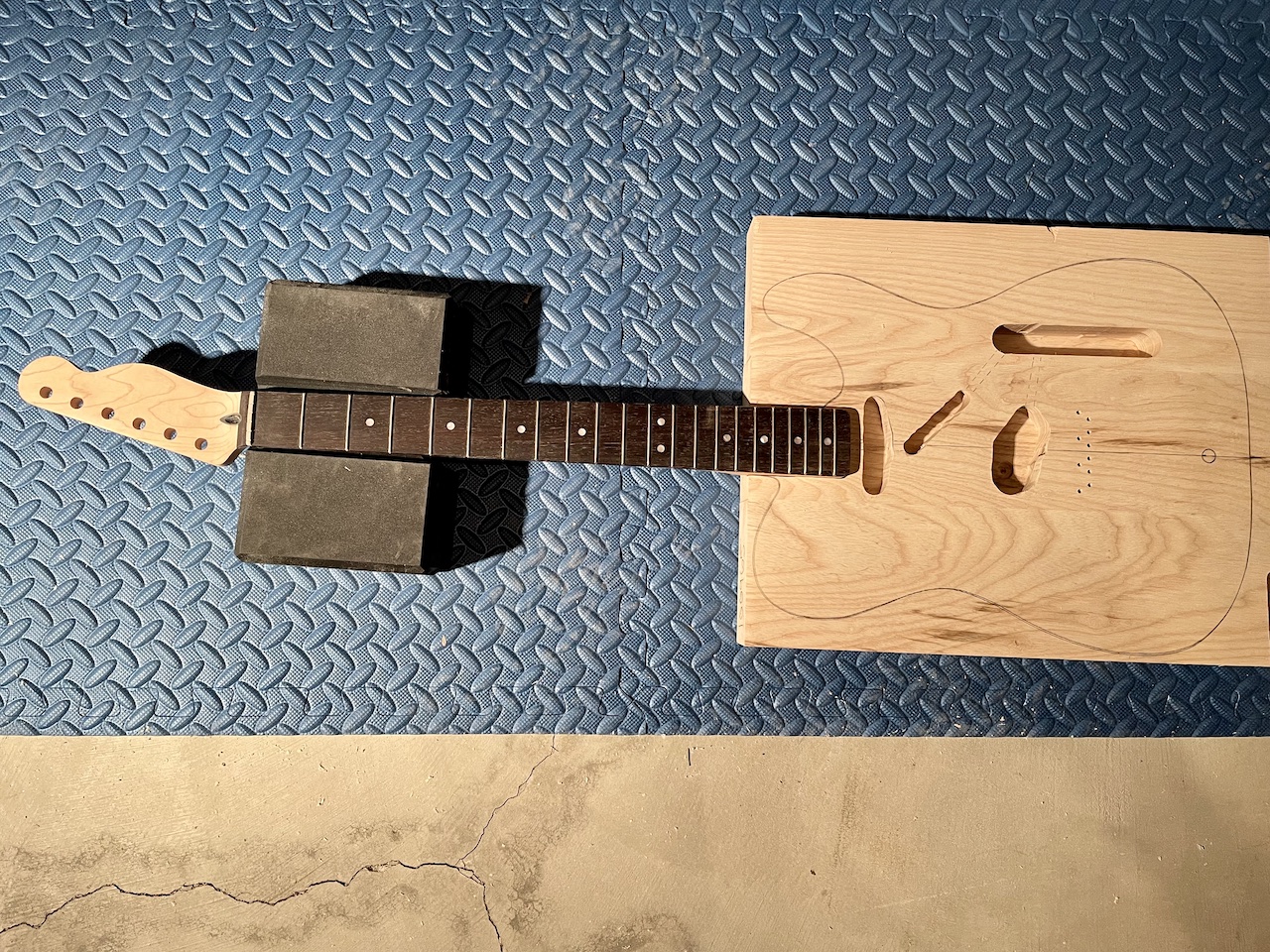 guitar neck fitted into routed neck pocket